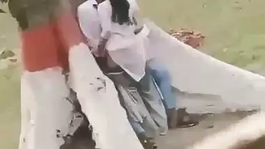 College couple enjoys outdoor sex below a big tree