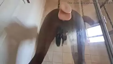 Indian slut fucking her pussy with a suction cup dildo that's stuck against glass door