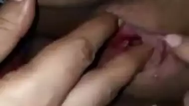 Indian woman touches her pink vagina with two hands in close-up porn
