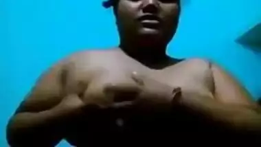 Mature Desi in a red sari exposes her big sex parts in a XXX show